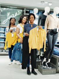 Three african woman posed near mannequins in clothes store. Shopping day at jeans sector.