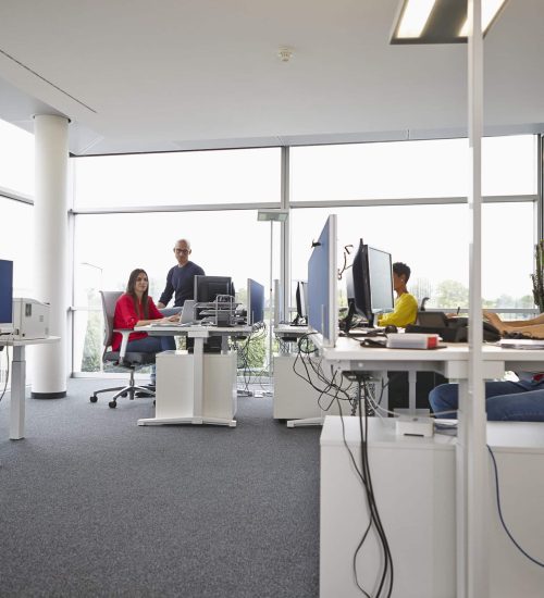 Colleagues working in open-plan office