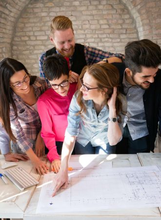 Picture of young attractive architects discussing in office
